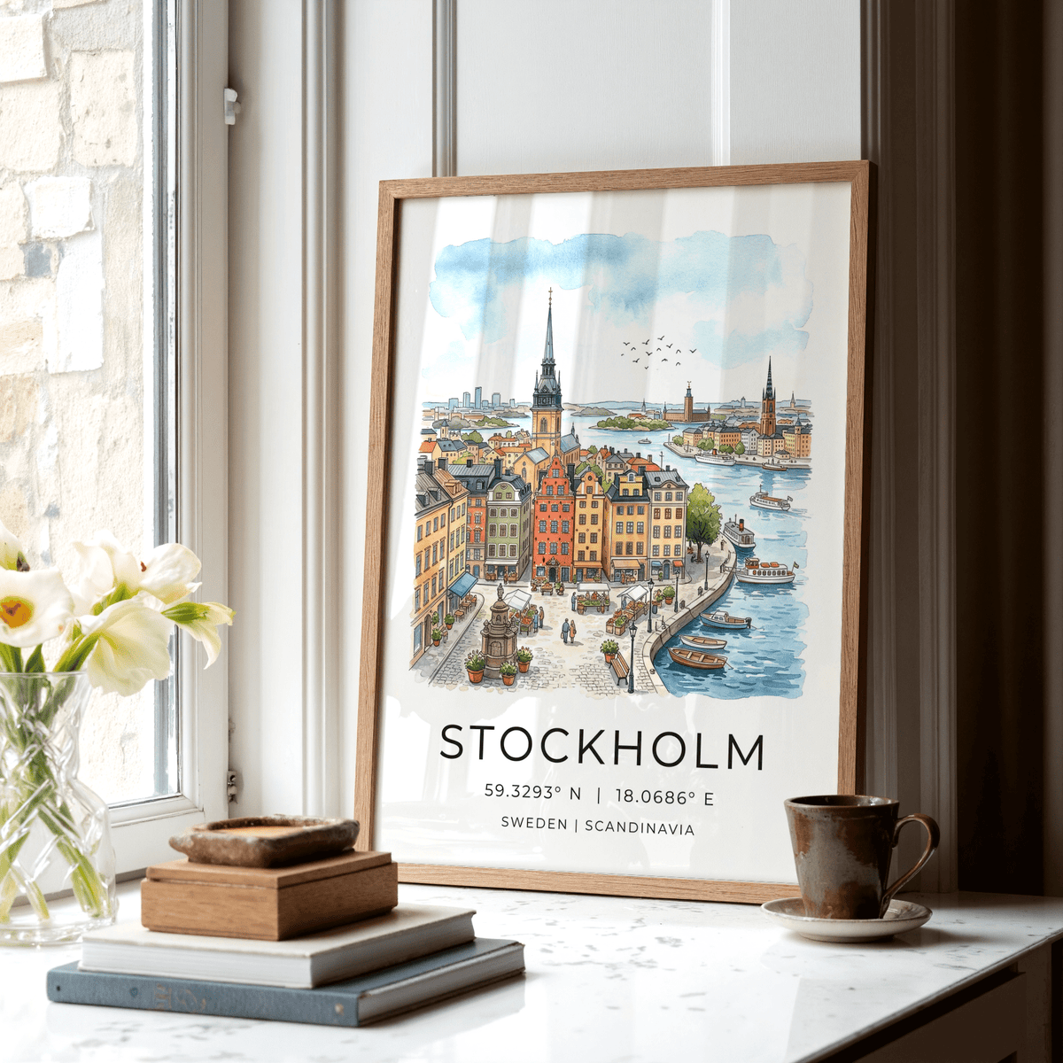 Print leaning on a surface of a Stockholm cityscape illustration in watercolour with warm tones and blue sky