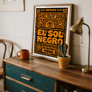Framed Mexican Culture Art Print with orange folk-art sun and eye symbol on teal dresser with lamp and cactus