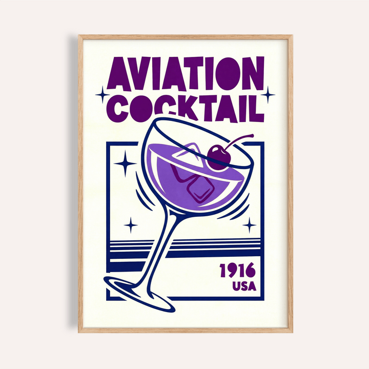 Framed Aviation Cocktail Print showing a purple cocktail glass with a cherry and typographic style