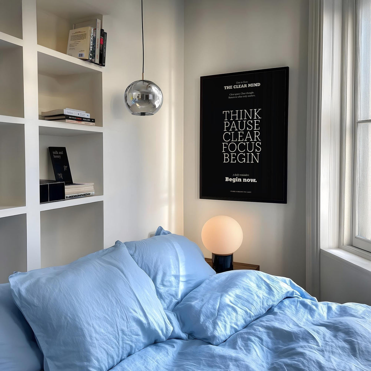 Motivational Quote Prints framed print with white text on black above a bedside lamp in a bedroom