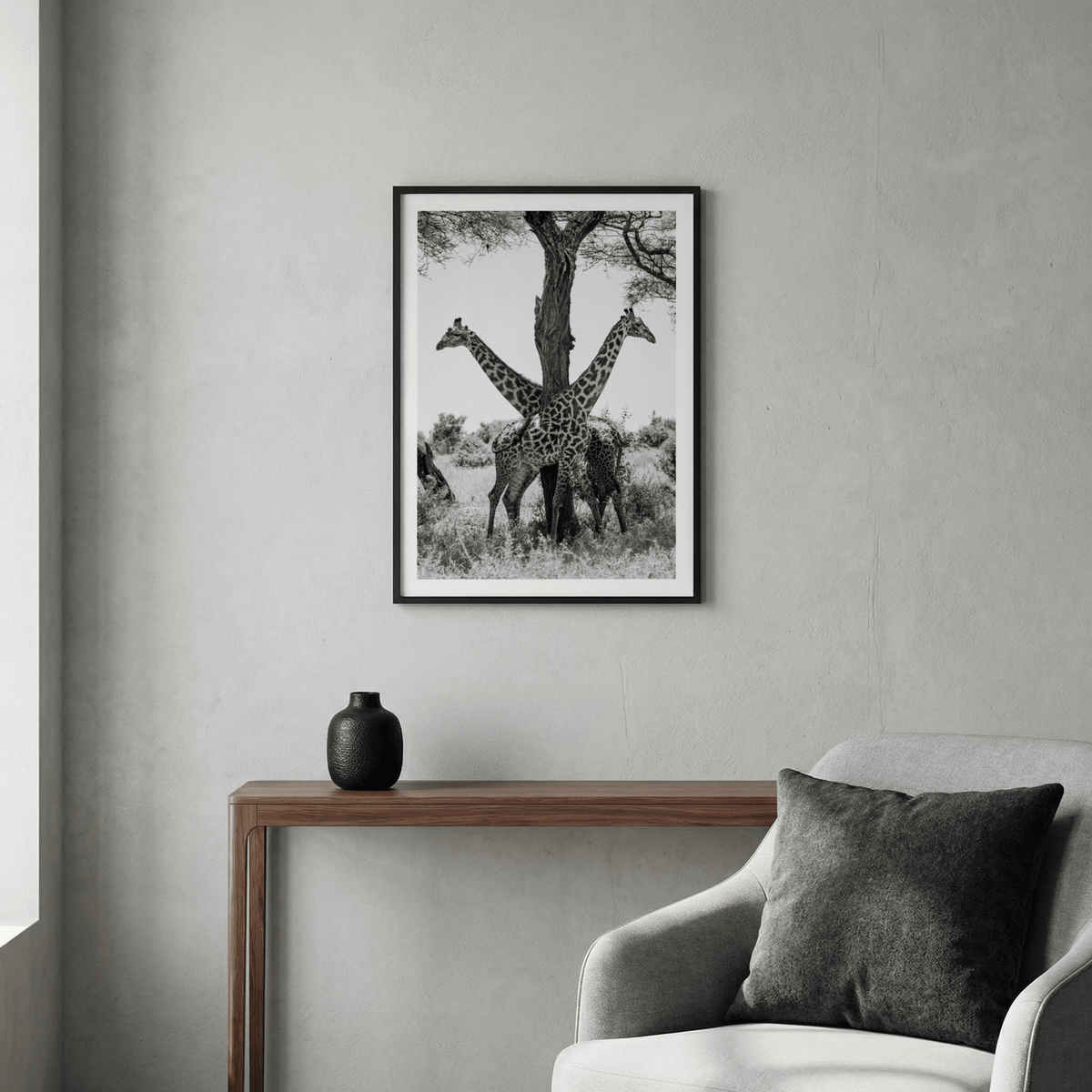 Framed Giraffe Black And White Art Print of two giraffes back to back above a wooden console table