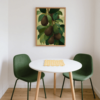 Avocado wall art illustration of hanging avocados in green and brown above a white table with green chairs