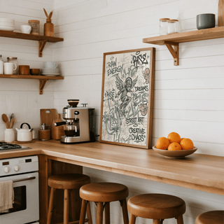 Street Art Poster print leaning on a kitchen counter with a bowl of oranges nearby