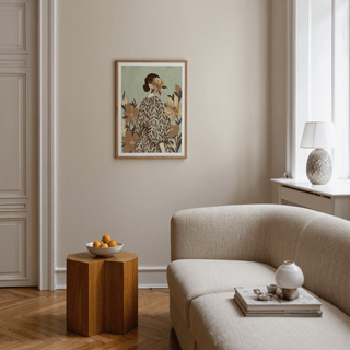 Print on a wall of Woman With Flowers showing a woman with a floral dress in muted green and beige tones in a living room
