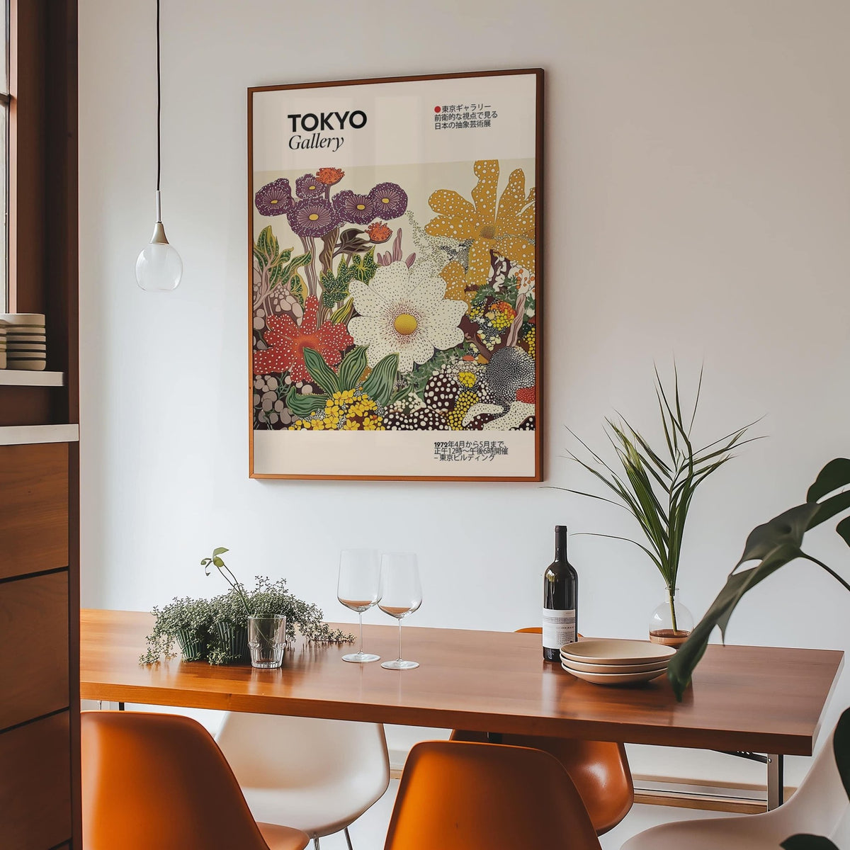 Japanese Flower Painting hung above dining table with orange chairs and plants