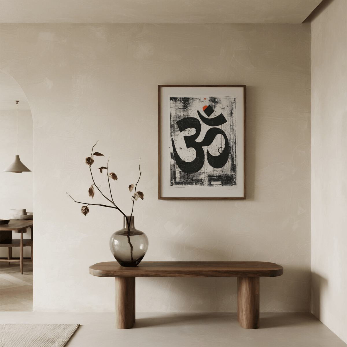 Abstract Om art print with black and orange hues above a wooden bench with a vase