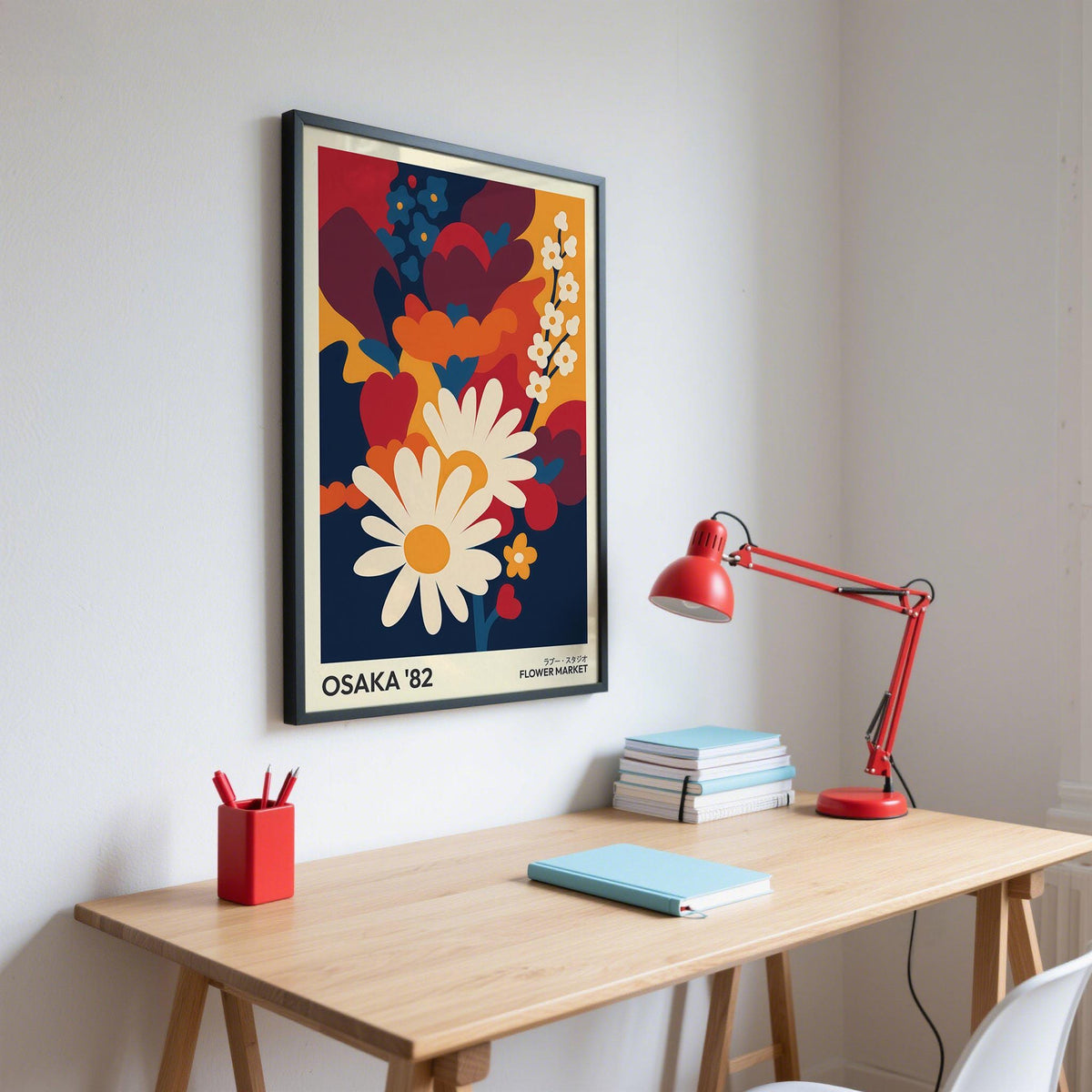 Art Flower Print on a wall with white daisies and colourful flowers above a wooden desk with a red lamp