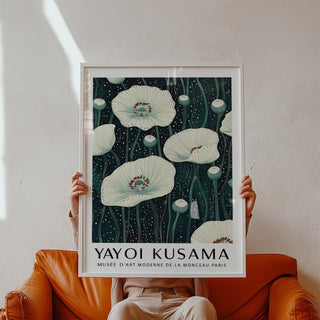 Framed Poppy Prints held in hands showing white poppy flowers on a dark background
