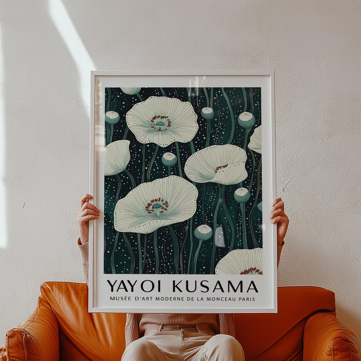 Framed Poppy Prints held in hands showing white poppy flowers on a dark background