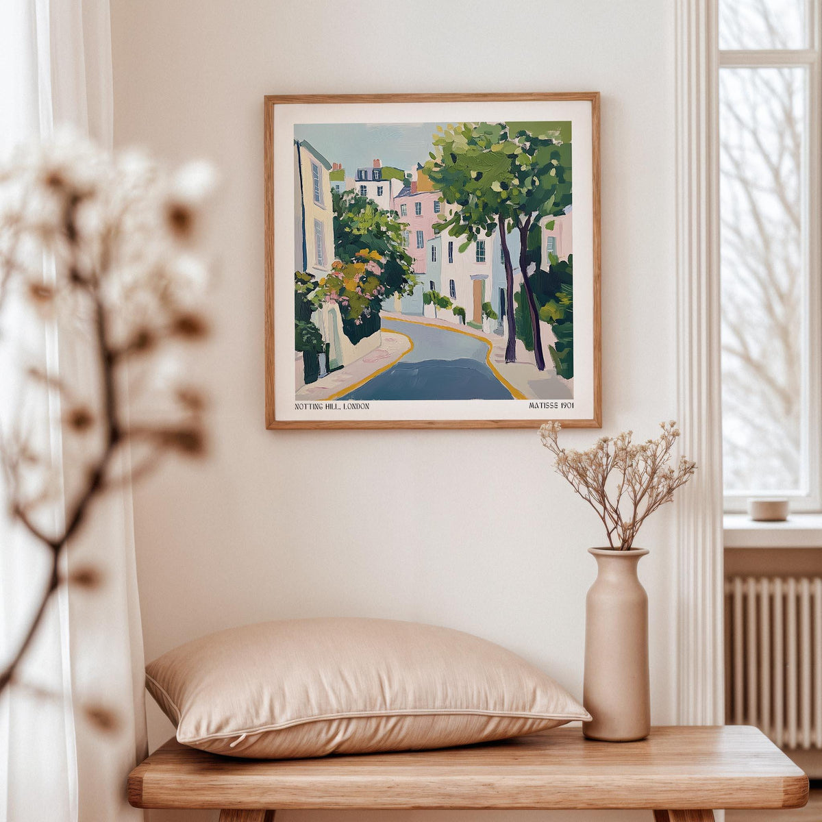 Notting Hill poster print of a pastel coloured street with trees above a table with a cushion and vase