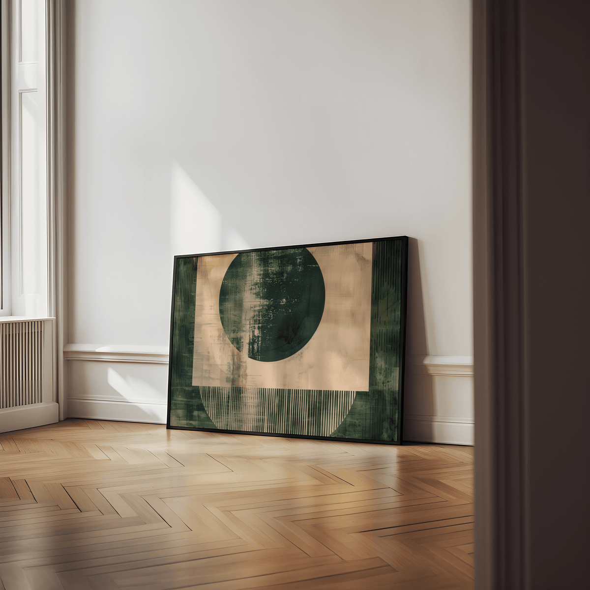 Abstract geometric poster leaning on a wooden floor with green and beige shapes in a bright room
