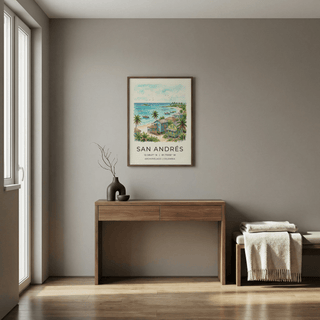 San Andres art print of colourful beach houses and palm trees hung above a wooden desk with a vase