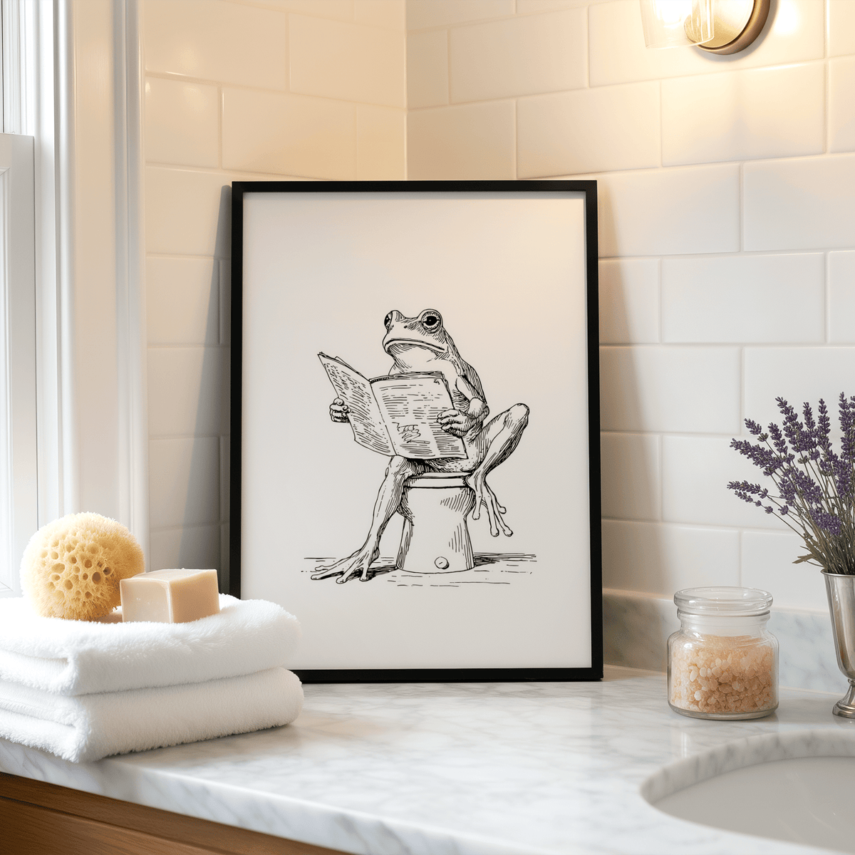 Framed Reading Frog Art Print line-art of a frog reading a newspaper on a bathroom counter with toiletries