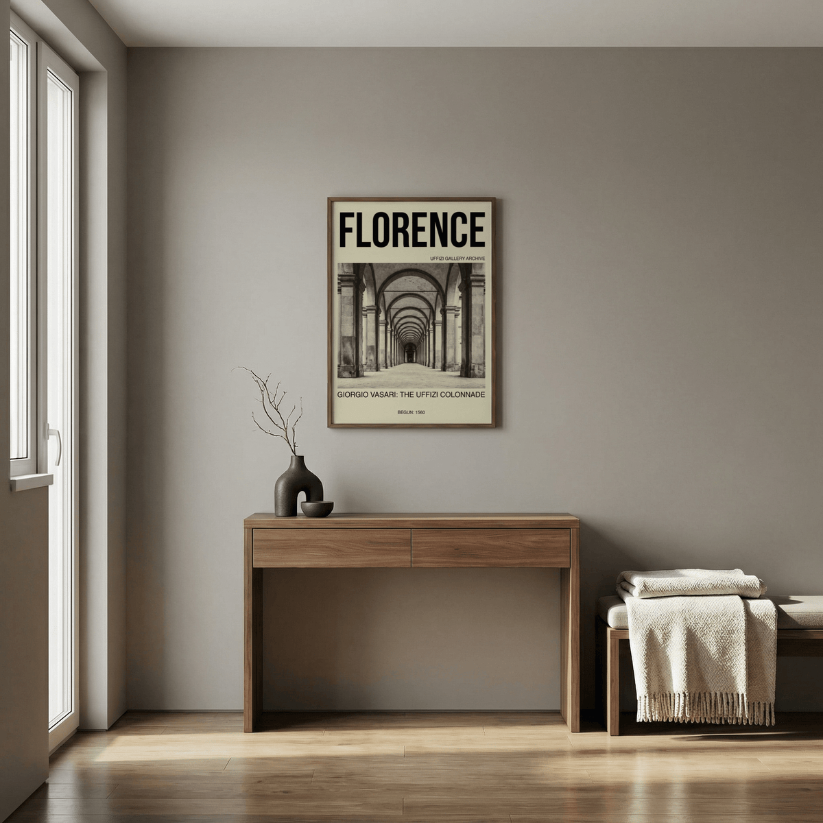 Florence Architecture Print framed on a grey wall above a wooden desk with a dark vase in a bright room