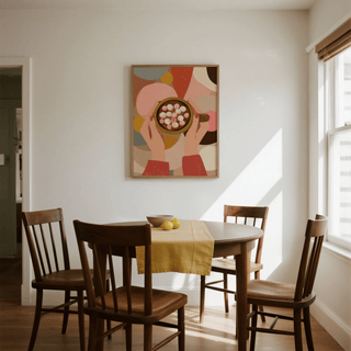 Hot Chocolate wall art of hands holding a mug with marshmallows in a dining room above a table with lemons