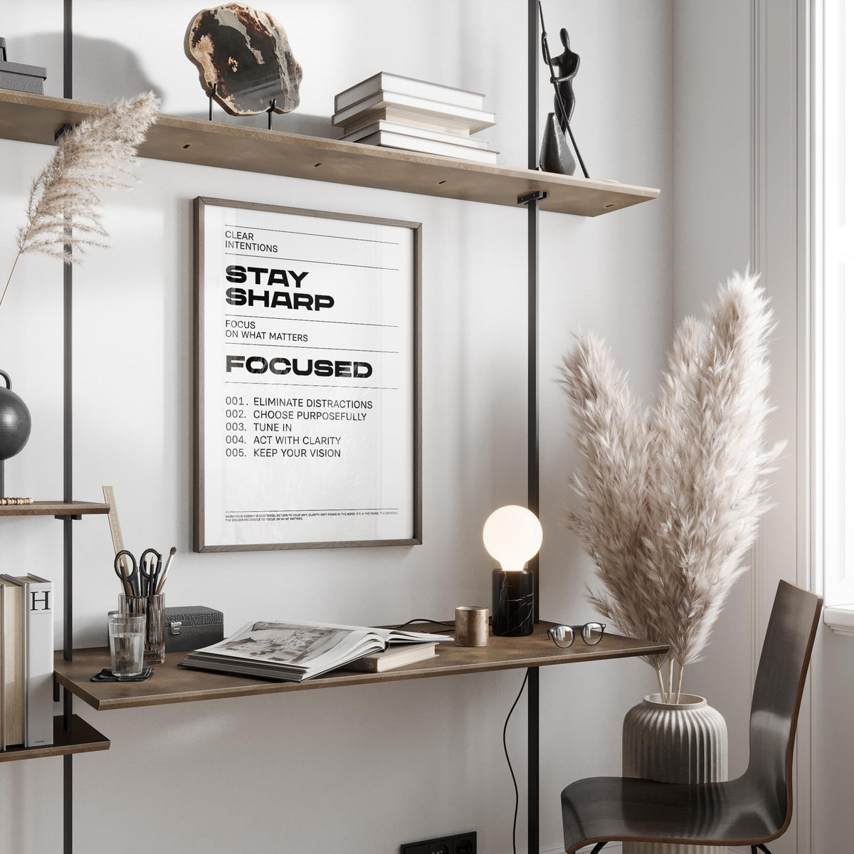 Framed Office Posters Motivational print with black text in a minimalist home office with brown shelves and pampas grass