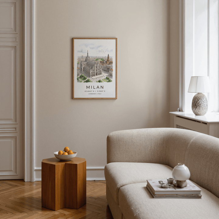 Milan Cathedral art print in watercolour and illustration style hung above a wooden side table with a bowl of fruit in a living room