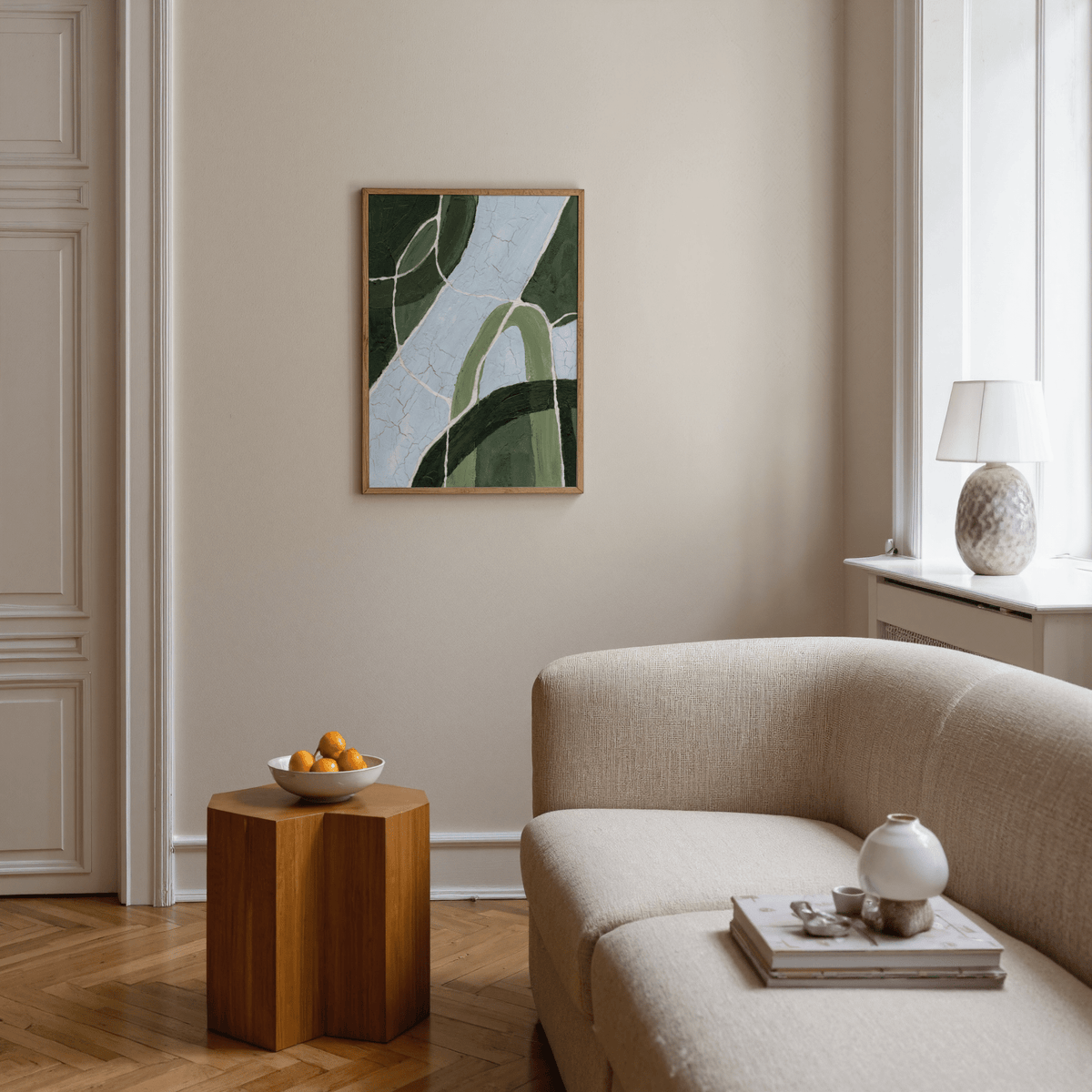Green and blue art abstract stream with green and blue tones above a wooden side table in a living room