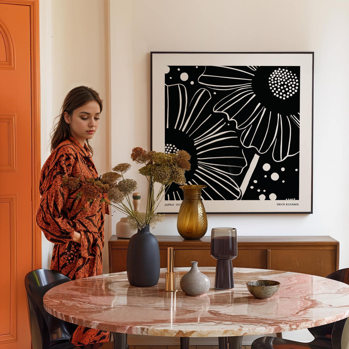 Black White Floral Art print on wall above wooden sideboard with vases in dining room