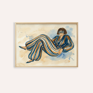 Framed print of a reclining figure in striped trousers and glasses in blue and beige tones