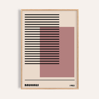 Close-up of Bauhaus 1923 Art with black horizontal lines and a pink square in a light wood frame