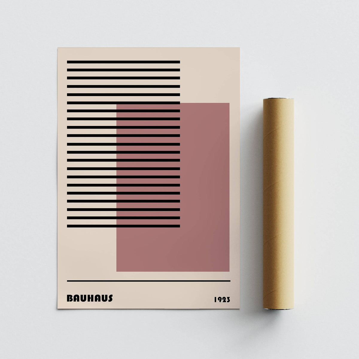 Rolled print of Bauhaus 1923 Art showing black lines and a pink square next to the packaging tube