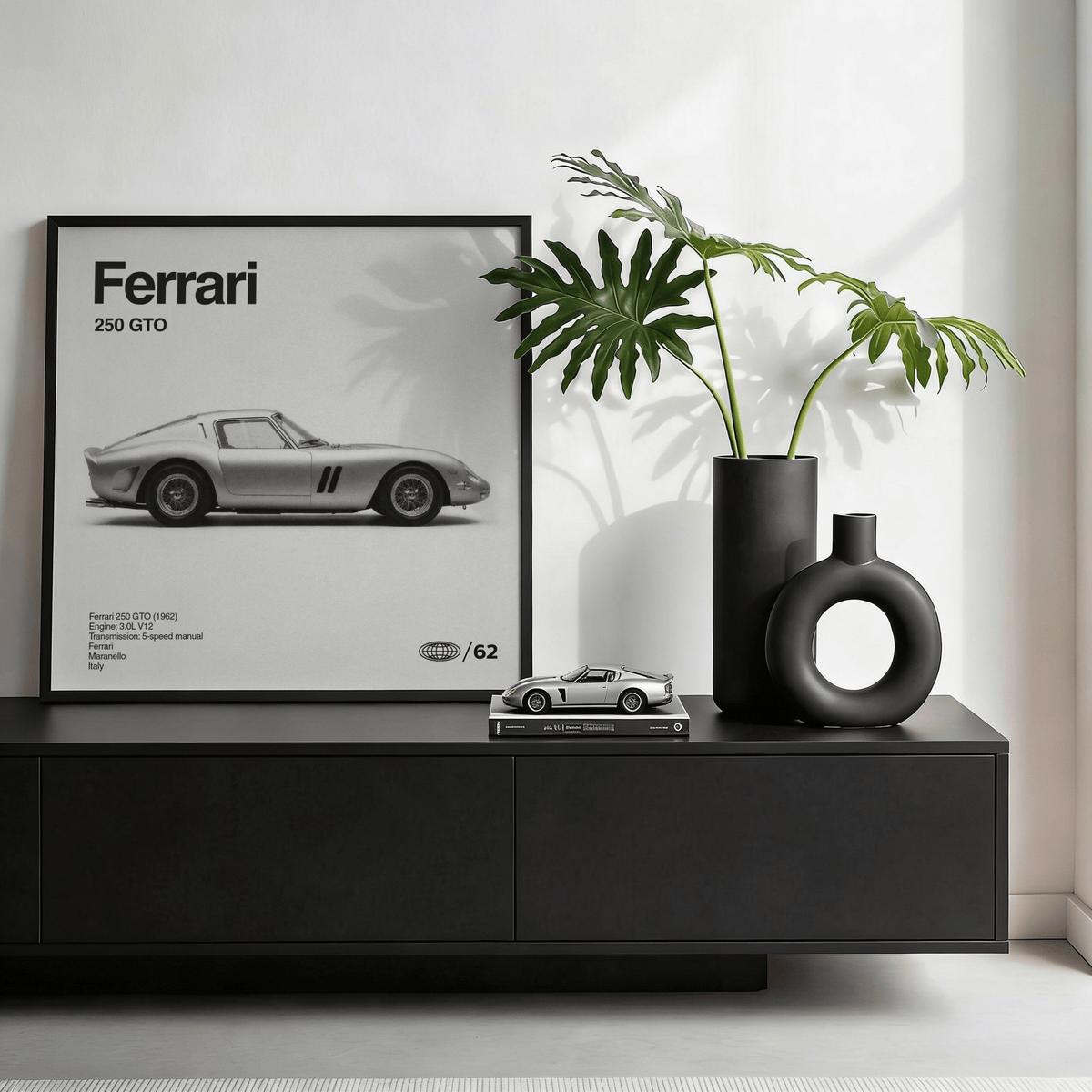 Classic Grand Tourer Poster leaning on a black sideboard with a green plant in black vases nearby