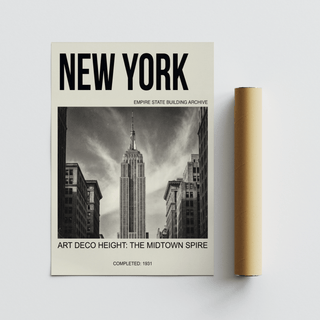 Empire State Building wall art with typographic design next to a brown packaging tube on a grey surface