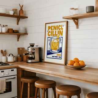 Bar Decor wall art leaning on kitchen counter with coffee machine and bowl of oranges nearby
