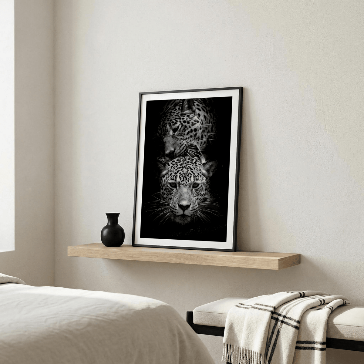 Leopard Photography Print leaning on a shelf with a black vase in a bedroom