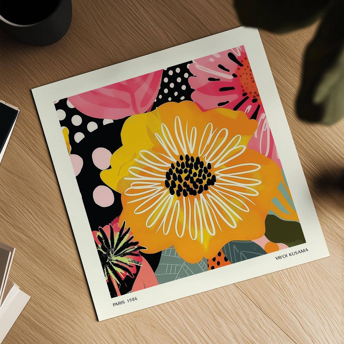Flower Posters showing a yellow flower with white petal lines on a wooden surface next to a black mug