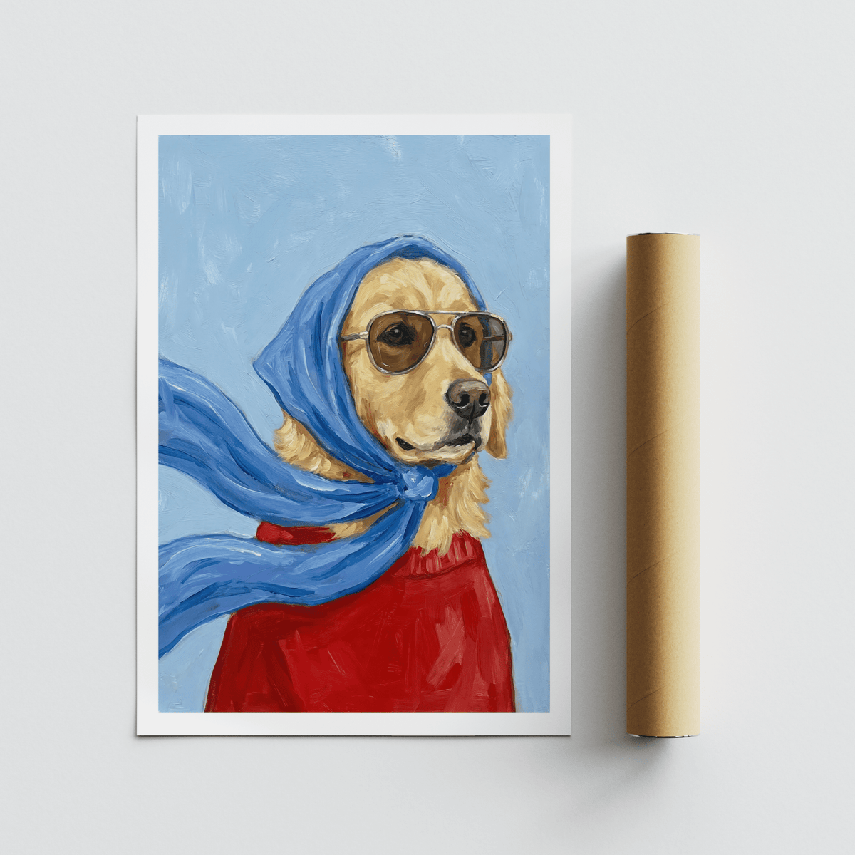 Golden Retriever Art print with a dog in sunglasses and blue scarf laid next to a packaging tube