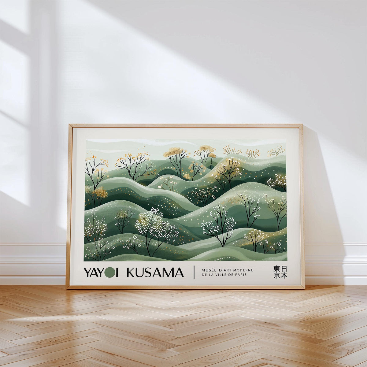 Landscape art prints of hills with blossoming trees in green and beige leaning on a wooden floor with sunlight