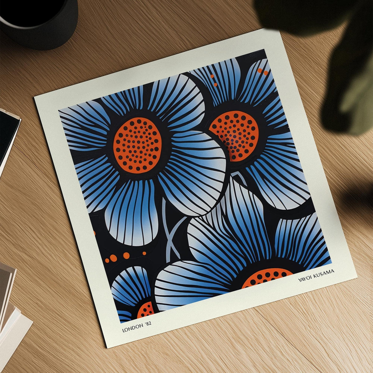 Blue Flower Wall Art showing blue and orange pop-art flowers with black detailing on a wooden surface