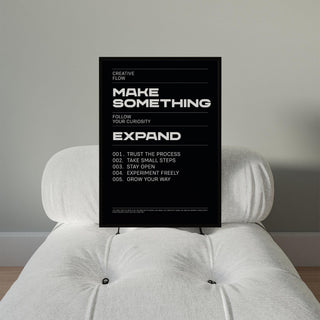 Wall Art Phrases motivational text poster with minimalist typography resting on a white cushioned chair