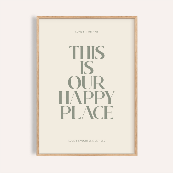 Framed print close-up with typography saying This Is Our Happy Place in muted green on cream background