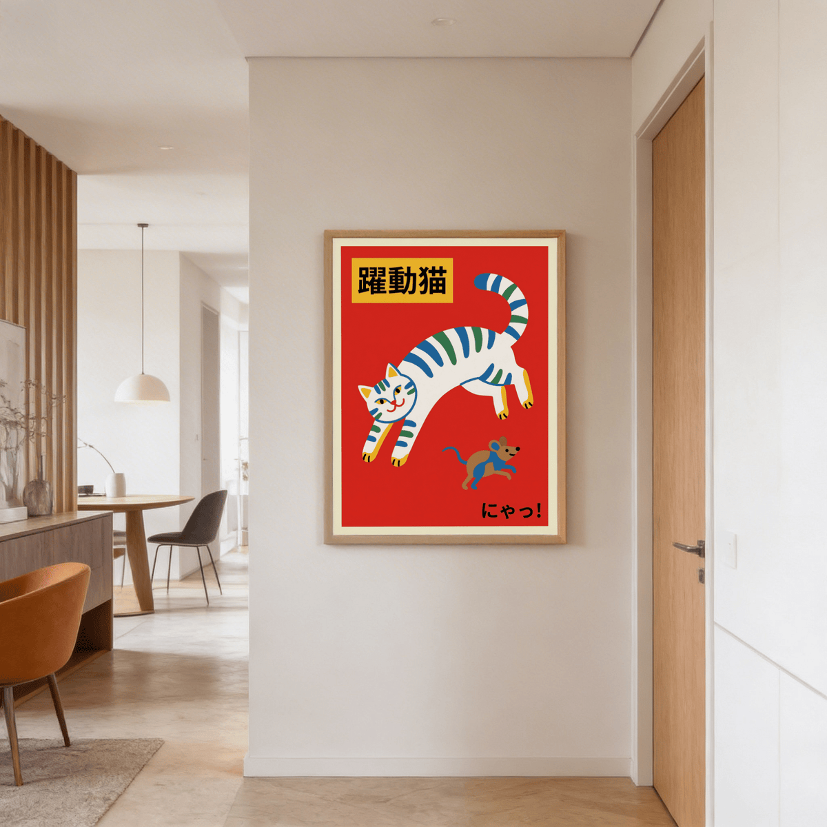 Print on a wall of a leaping white cat with blue and green stripes and a mouse next to a door