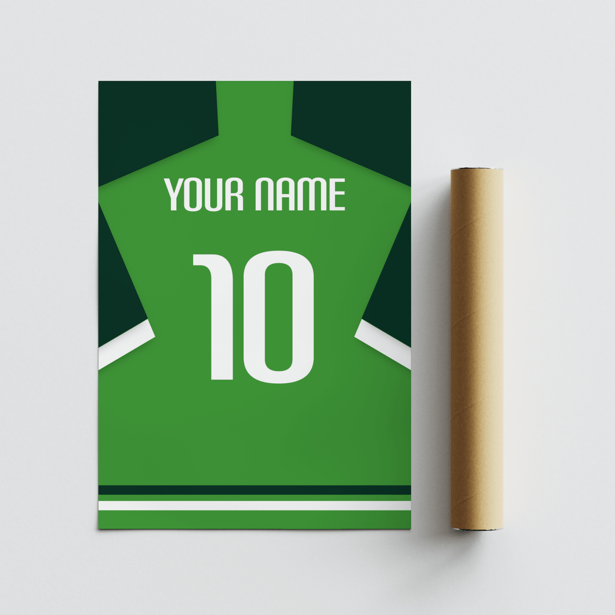 Roll of packaging beside football shirt poster in green with dark green sleeves on a flat surface