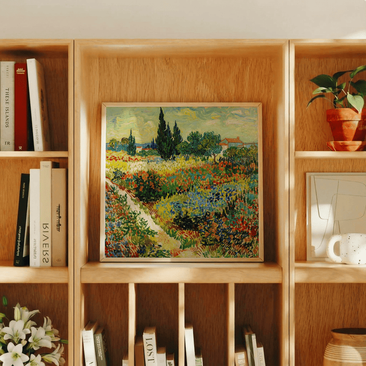Colorful Landscape Art Print wildflower field with green and orange tones on a wooden shelf with books and a potted plant