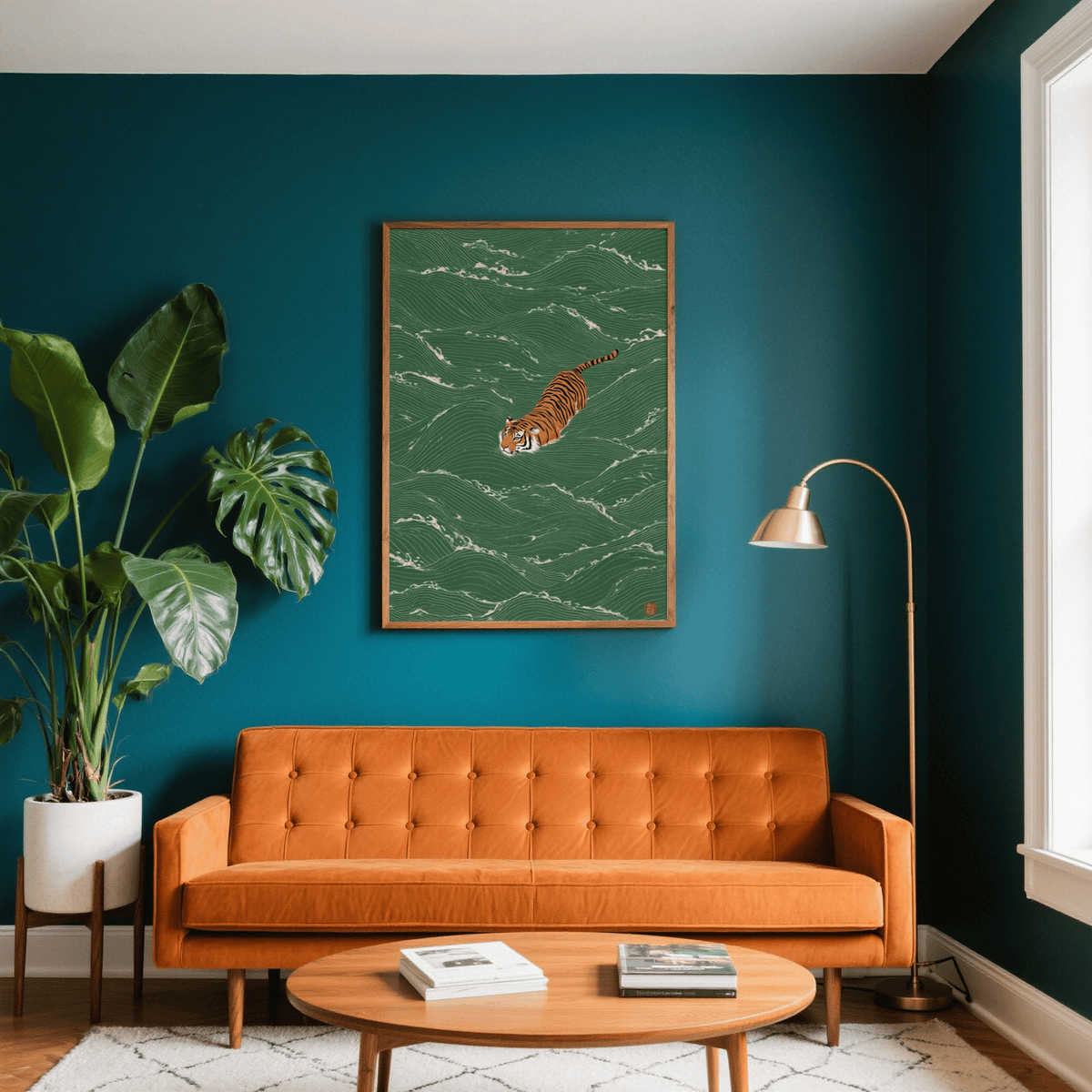 Wildlife wall decor of a minimalist swimming tiger illustration on a green background above an orange sofa