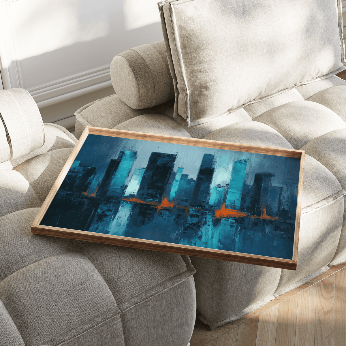 Blue artwork city abstract city skyline with blue and orange reflections on a beige sofa