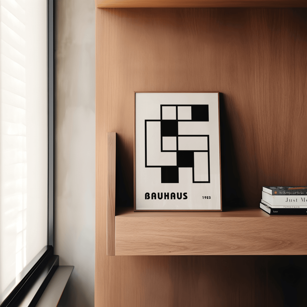 Minimalist Block Art print leaning on a wooden shelf next to a stack of books