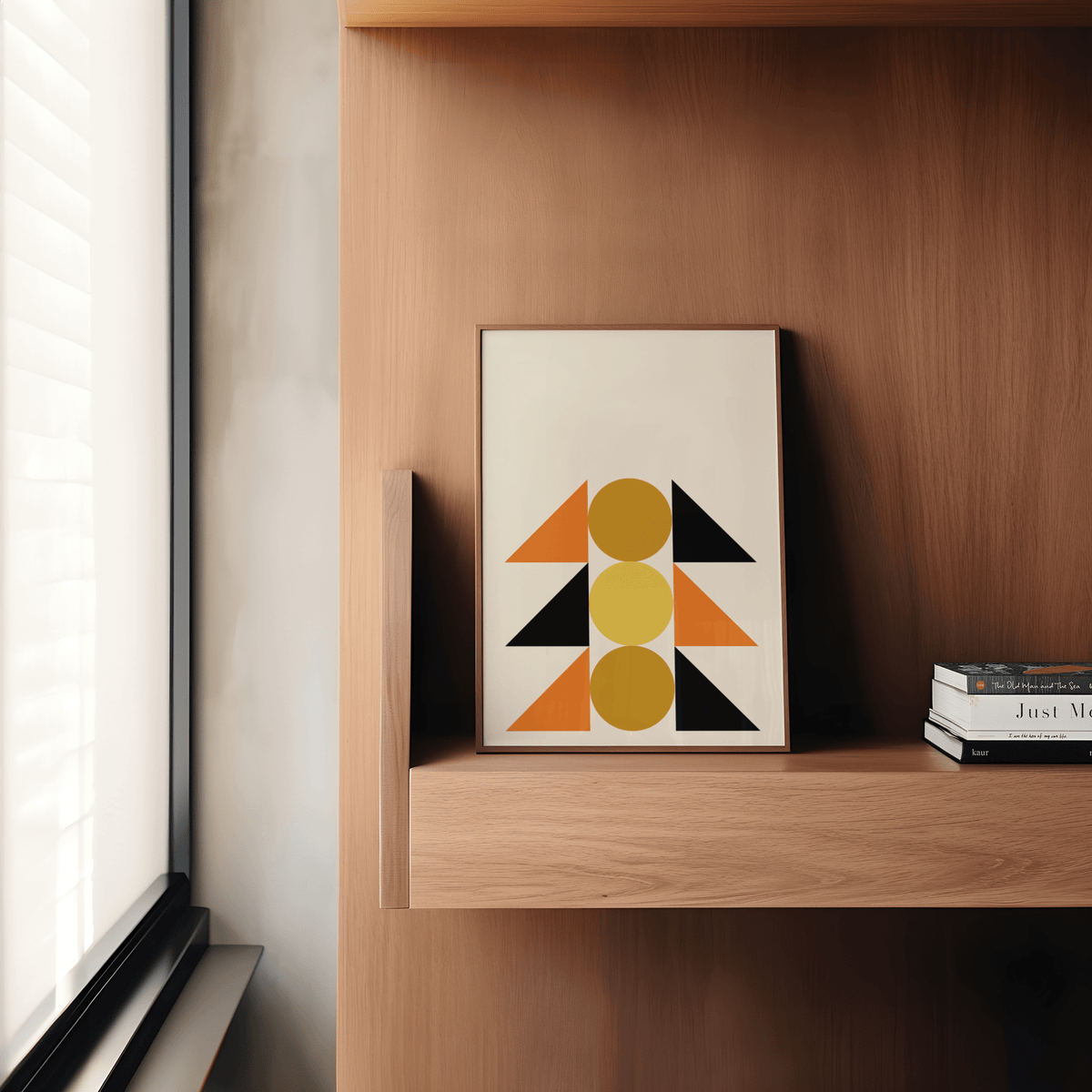 Geometric Block Art print leaning on a wooden shelf next to stacked books with warm tones
