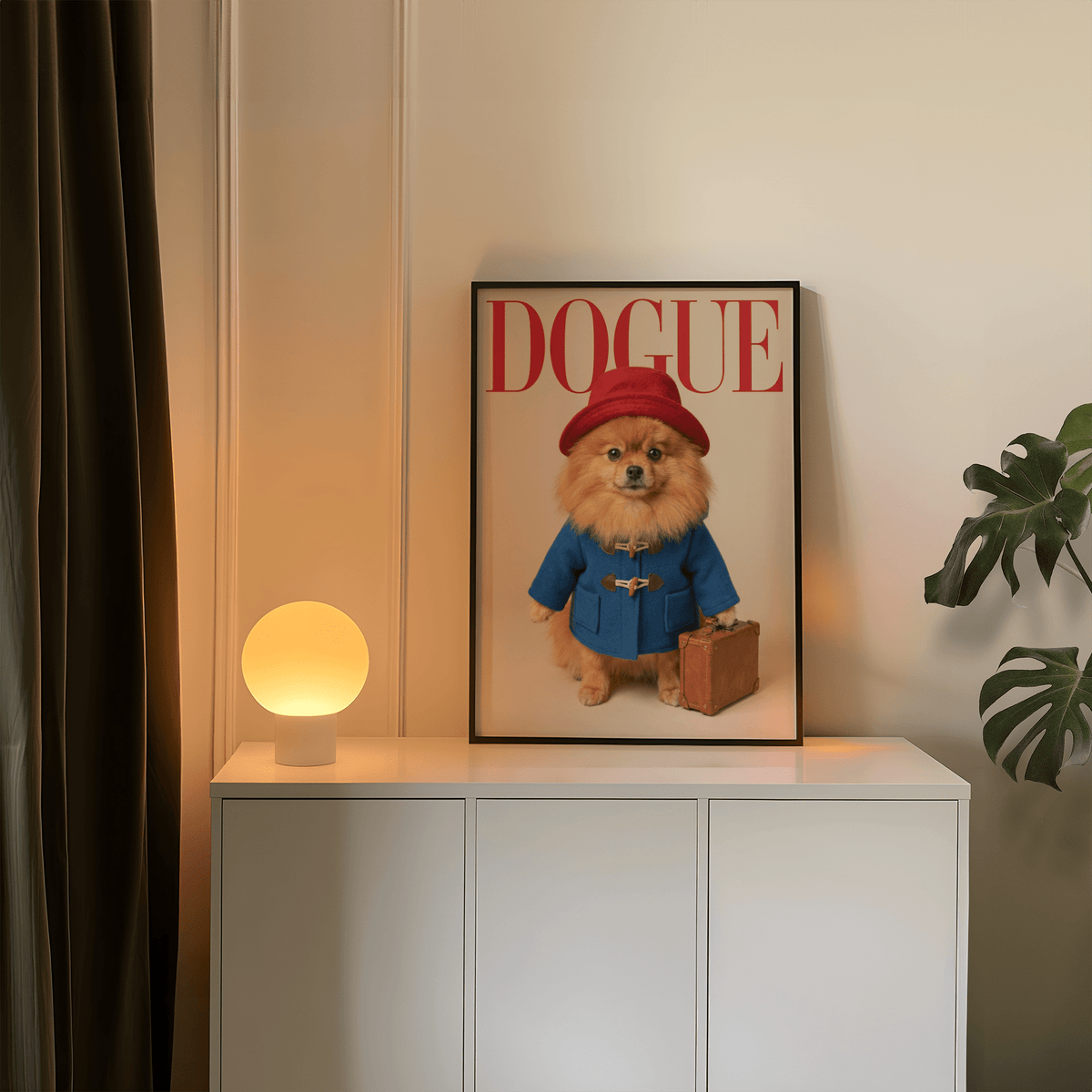 Pomeranian Poster framed print leaning on a white cabinet beside a round lamp and plant