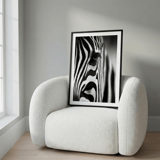 Framed wildlife photography poster of zebra stripes with eye detail on a textured white chair