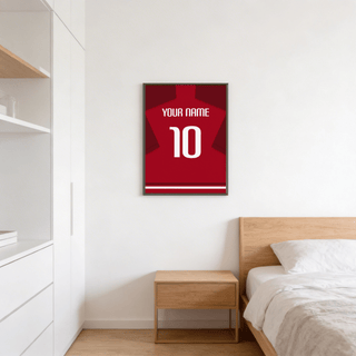 Football Shirt Poster in Red with Dark Red Sleeves on wall above wooden bedside table in bedroom