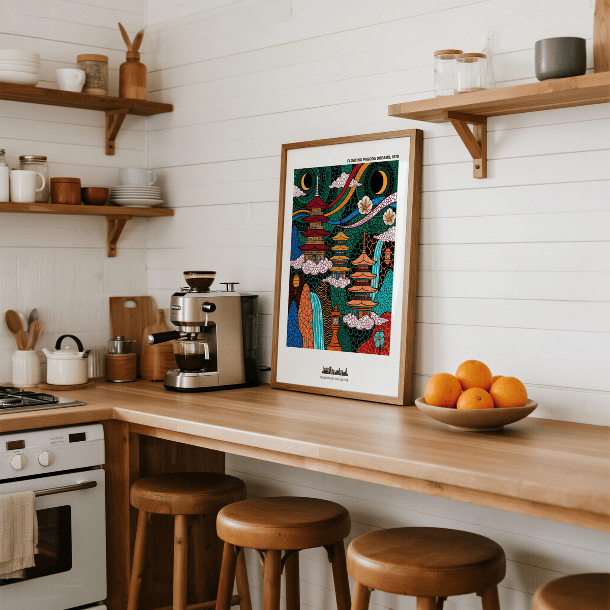 Japanese Pagoda wall art leaning on a kitchen counter with a bowl of oranges nearby