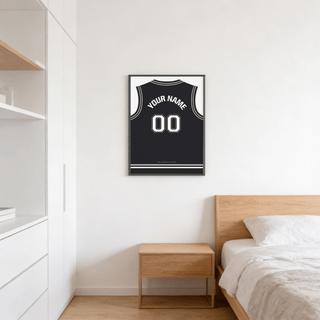 Basketball Jersey Poster in Black with White Number hanging above a wooden bedside table in a bedroom