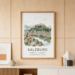 Framed Salzburg City Print showing a watercolour cityscape with green hills above a white sideboard with vase