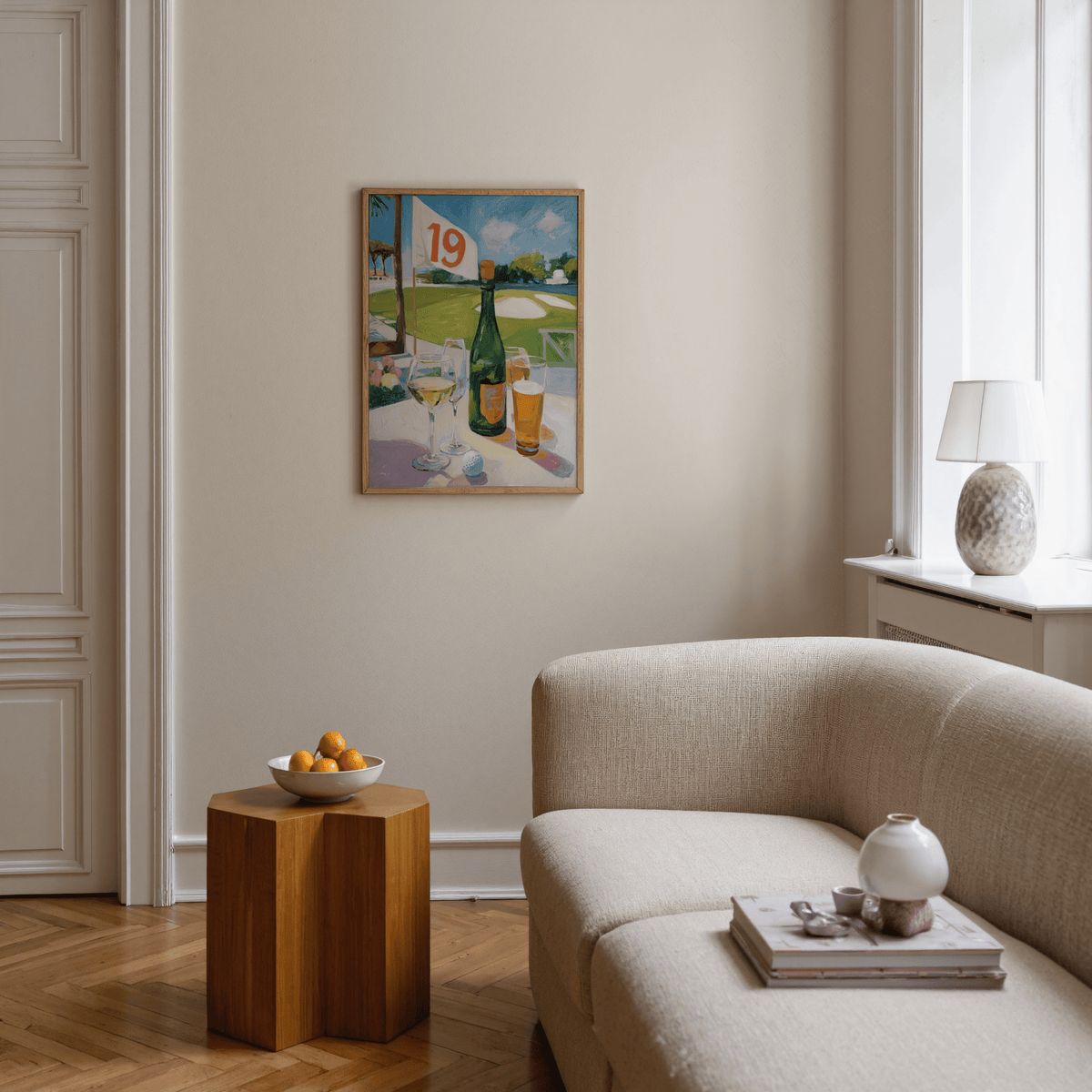 Print on a wall in a living room showing golfing drinks with a green bottle and glasses near a golf course scene